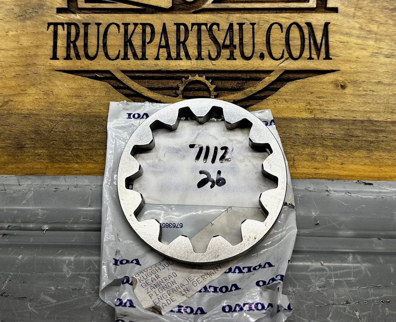 Front view of a genuine Volvo Penta 840553 toothed gear ring resting on an OEM Volvo Penta parts bag; NOS condition.